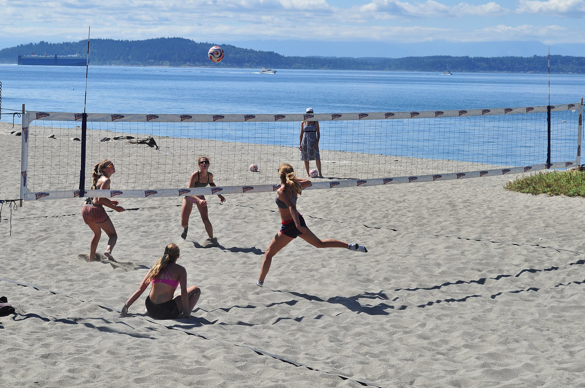 Beach volleyball on sand near the water