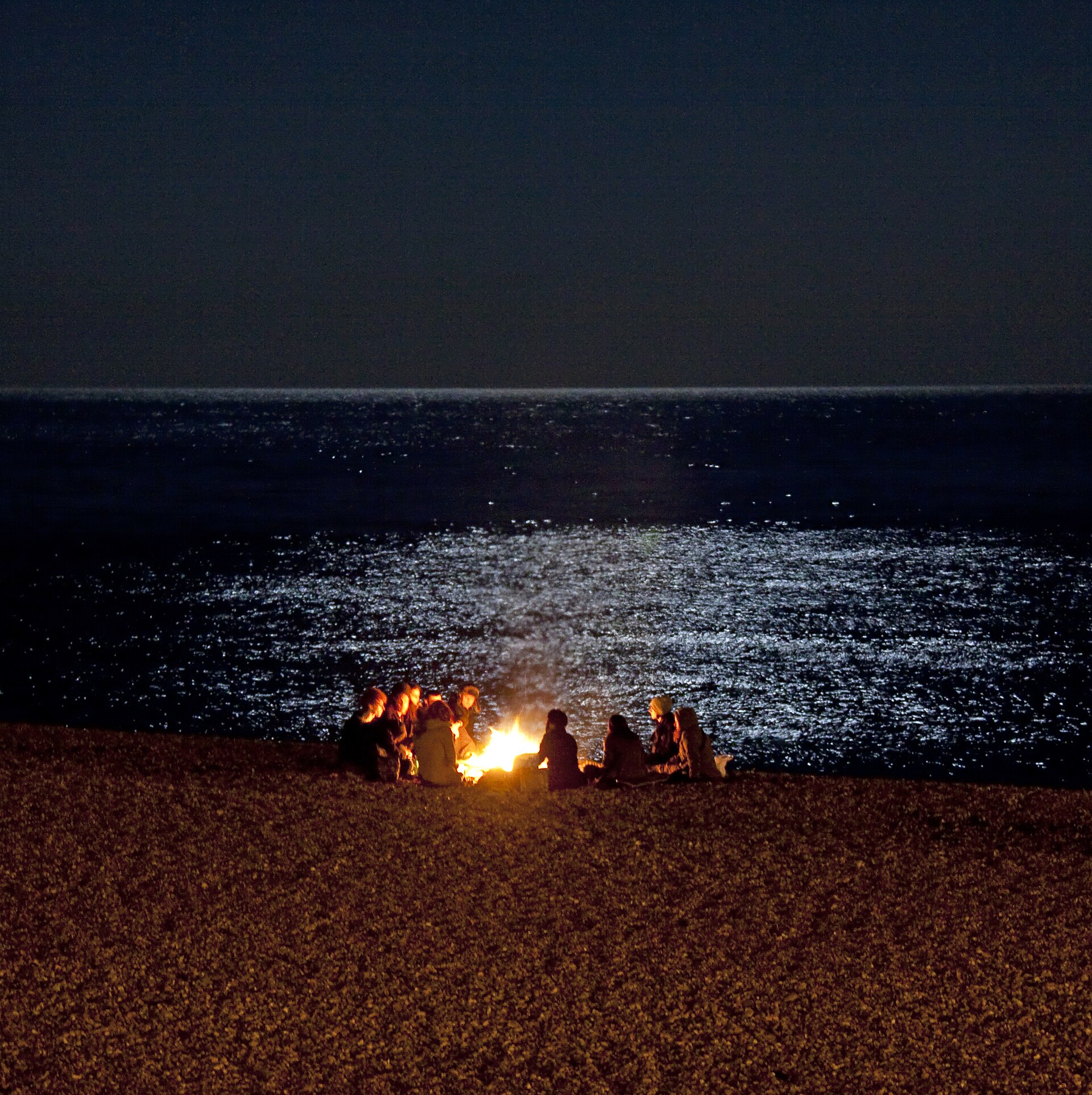 Late night beach party lights and crowd